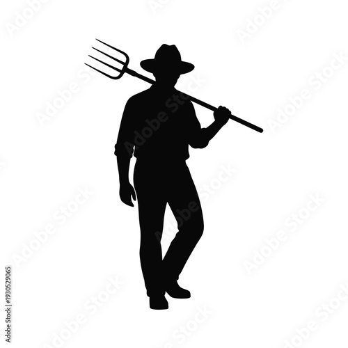 Farmer silhouette walking with pitchfork on shoulder outdoors in rural landscape viewed from side