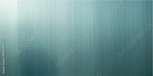 A brushed metal plate texture features a blue gradient design on a dark steel surface, creating a blank industrial backdrop with light grunge patterns for a modern wallpaper or vintage material art