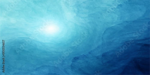 Abstract blue background of a frozen iceberg floating in the deep sea under a bright summer sky with sunlight reflections on the ocean waves