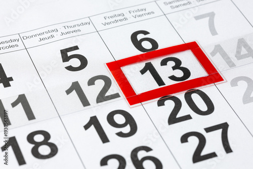 Showing friday the 13th on paper calendar. Marked date of 13 Friday.  Selective focuc on 13 number.