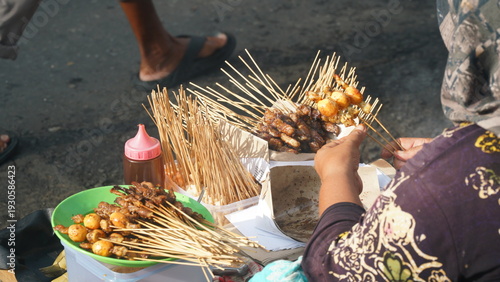 Traditional satay skewers sold by a street vendor in Yogyakarta