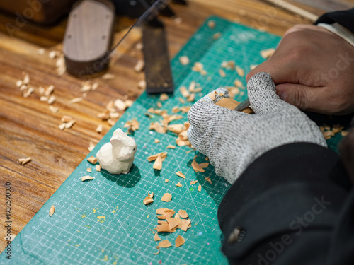 Craftsman Carves Rabbit Wood Sculpture