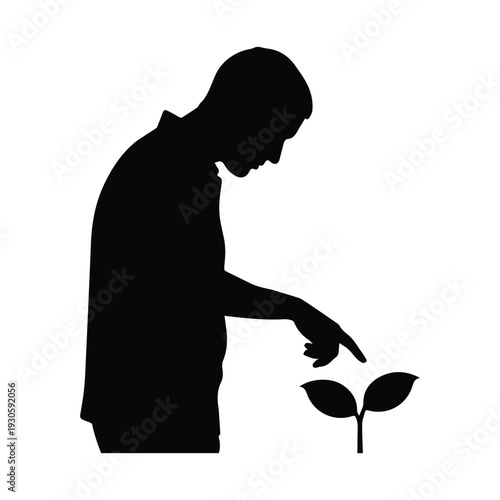 Man nurturing a small plant with care and attention to detail