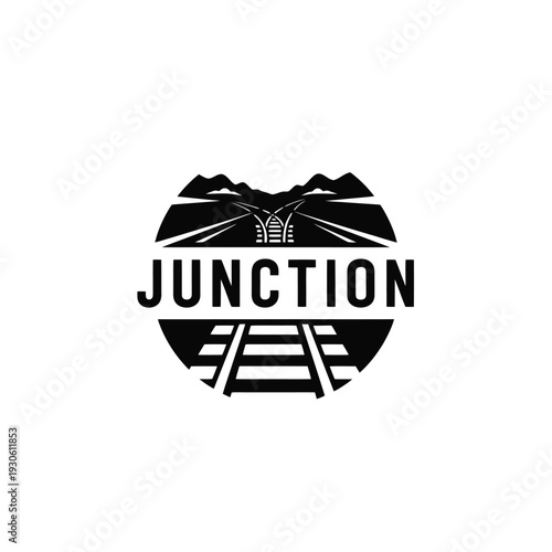 Black and white logo of a junction with railroad tracks and mountains.