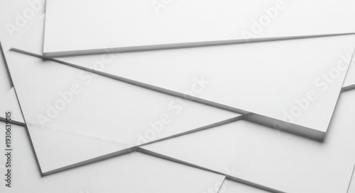 Overlapping white paper sheets with shadow effects.