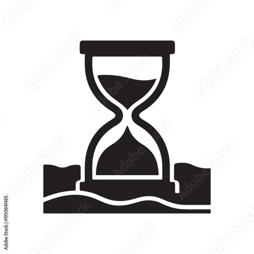 A black hourglass sitting on sandy beach with waves