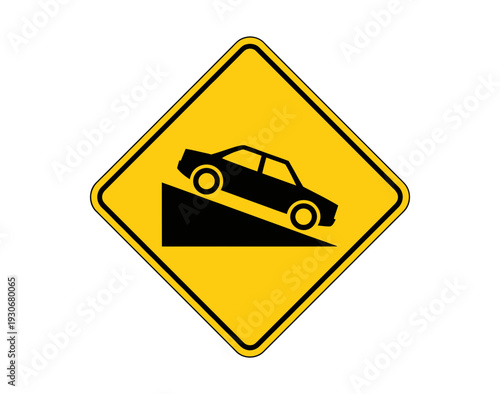 A yellow road sign with a black silhouette of a car sliding off a cliff