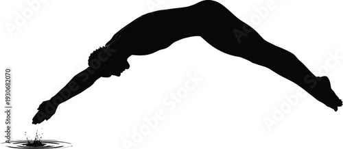 Silhouette of a competitive diver executing a perfect entry into dark water with a small splash.