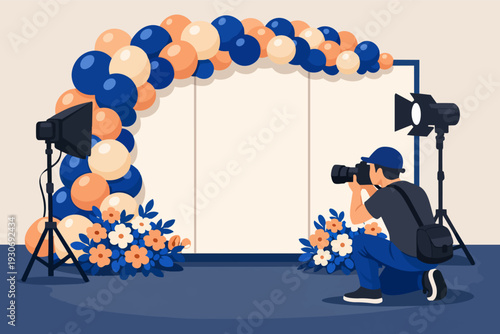 Photographer creating studio setup for event photoshoot with balloon arch backdrop
