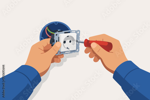 Electrician installing electrical outlet with screwdriver, wiring new power socket