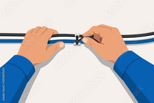 Hands organizing wires with a zip tie for effective cable management
