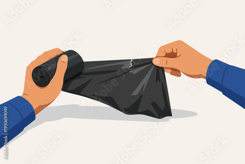 Hands tearing a black plastic garbage bag from a roll for household waste disposal