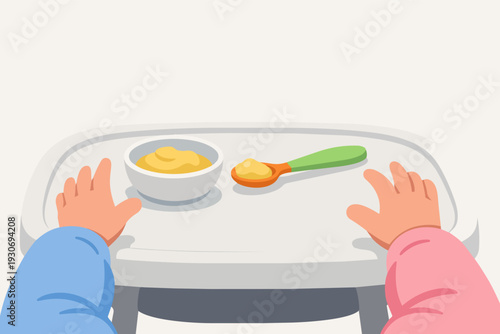 Baby's hands reaching for a bowl of puree and spoon on a highchair tray