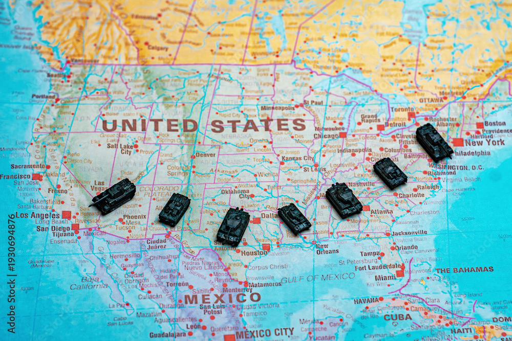 Obraz premium Miniature military tanks on map representing USA national defense.