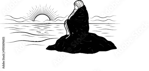 Woman wrapped in blanket on rock at sunrise by the ocean