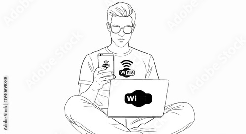 Young man with glasses sits cross-legged with laptop and phone