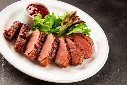 Duck breast dish main course slices poultry meat tasty snack fresh gourmet food background on the table rustic food top view copy space marketing concept photo