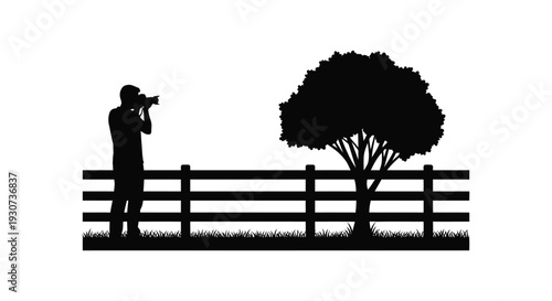 A photographer stands with camera observing nature by a fence and tree presented as a silhouette high quality professional detailed modern