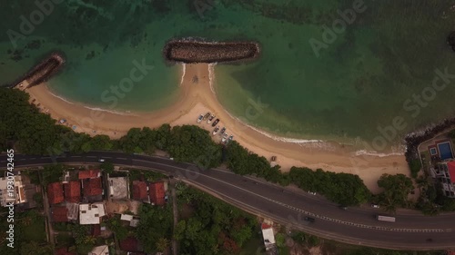 Drone footage of colorful fishing boats anchored in tropical ocean