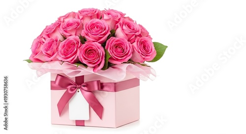 A bouquet of pink roses in a decorative gift box with ribbon