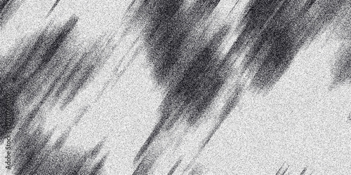 Abstract monochrome grainy texture with diagonal dark smudges and speckled white background creating a dynamic, textured visual effect for graphic design and backgrounds