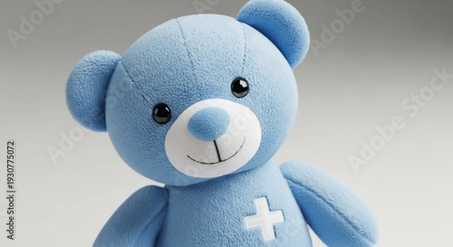 A soothing blue teddy bear plush toy with a cross symbol for comfort and care