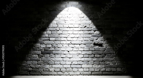 Dramatic spotlight on old brick wall in dark room