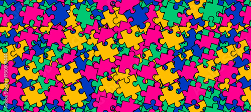 World Autism Awareness Day Pattern, poster or background design. Vibrant Seamless Background of Overlapping Multi-Color Puzzle Pieces in Pink, Blue, Yellow, and Green to Represent Neurodiversity.