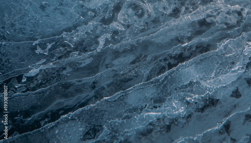 Water Flows Over Ice in a River During the Day in Winter Season