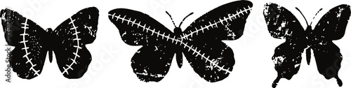 Three black silhouette butterflies with stitched patterns on wings in vintage isolated