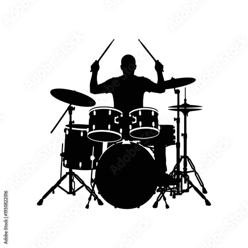 Silhouette of a Drummer Performing with a Drum Set and Sticks.