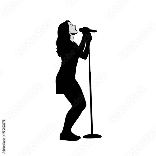 Silhouette of a female singer performing with a microphone on stage.
