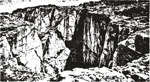 Rugged canyon landscape with rocky cliffs and deep crevices under clear sky