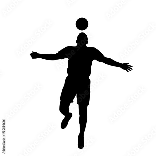 Silhouette of a male soccer player jumping to head a ball mid air.
