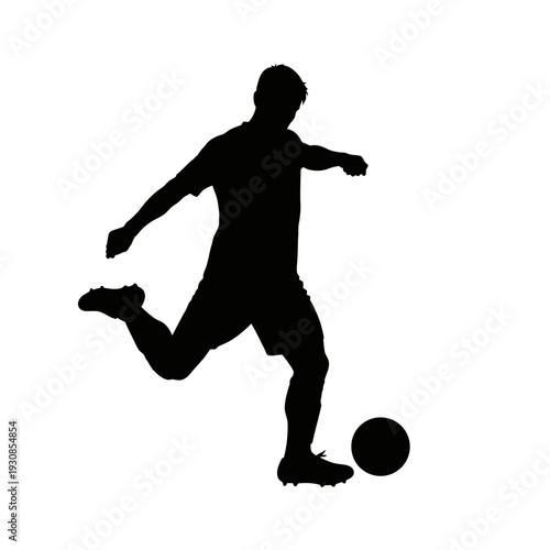 Silhouette of a soccer player in mid kick with ball in action.