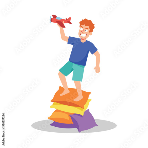 Boy standing on pillows playing with toy airplane.