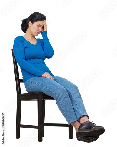 Full length portrait of a fatigue woman sitting slumped on a chair keeps hand to forehead, looking down isolated on transparent background. Overwhelmed and anxious lady feels distress and headache
