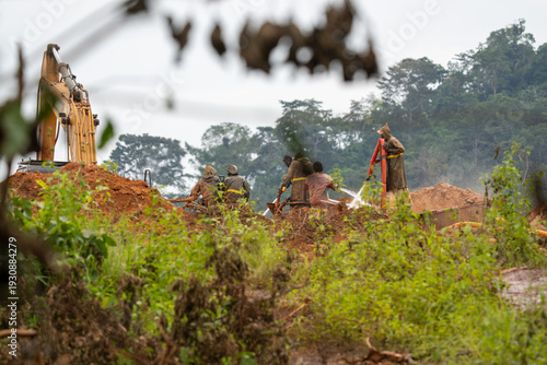 Close-up of an artisanal gold miner panning for gold in a stream in Atewa Forest.
