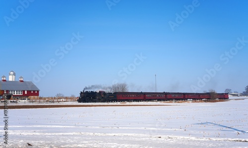Steam engine train in the snow landscape