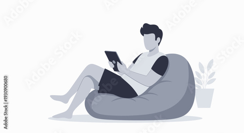 Relaxed Man Browsing Tablet While Reclining Comfortably In A Beanbag With A Plant Nearby