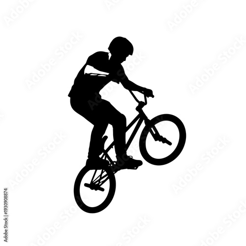 Silhouette of a cyclist performing a BMX stunt midair on a street park.