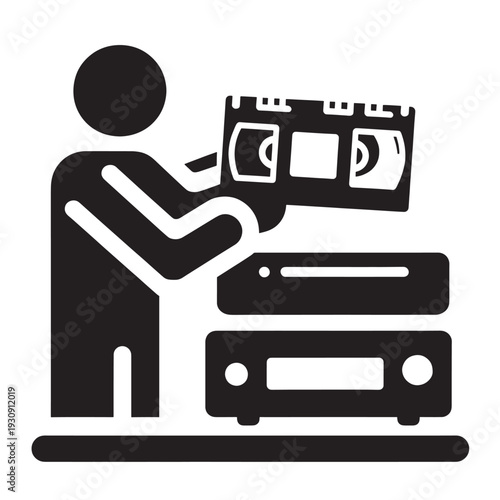 Person holding VHS tape with VCR player, silhouette of a man with video cassette and retro media playback device.