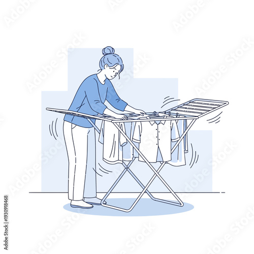 Woman Arranging Clothes On Drying Rack Demonstrating Everyday Household Task Routine