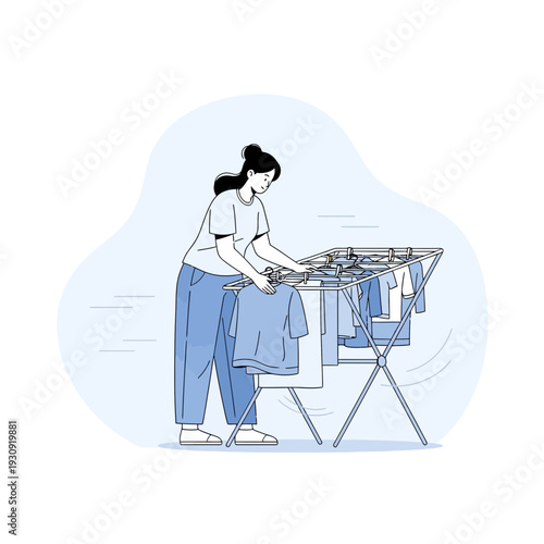 Woman Hanging Laundry To Dry On A Clothes Rack