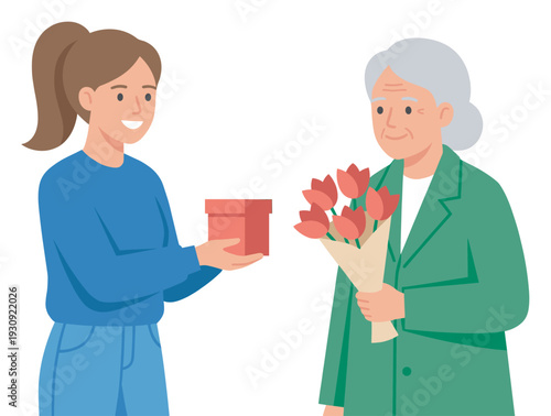 Young woman gives gift box to older woman holding a beautiful bouquet of tulips, sharing a heartwarming moment of appreciation.