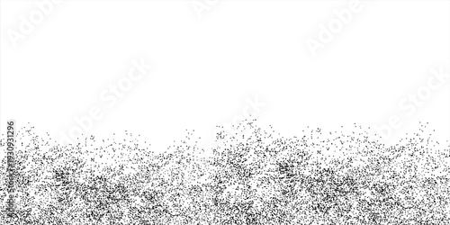 Black particles splash on a white background. Black powder dust scatters below.