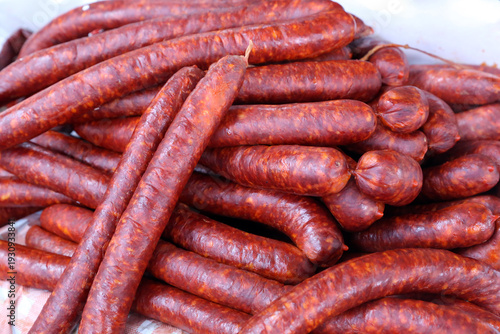 Close up of traditional hungarian homemade sausage aka kolbasz on farmers market for sale. Group of traditional hungarian sausages