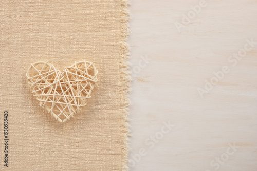 Decorative wicker rattan heart on a fabric background