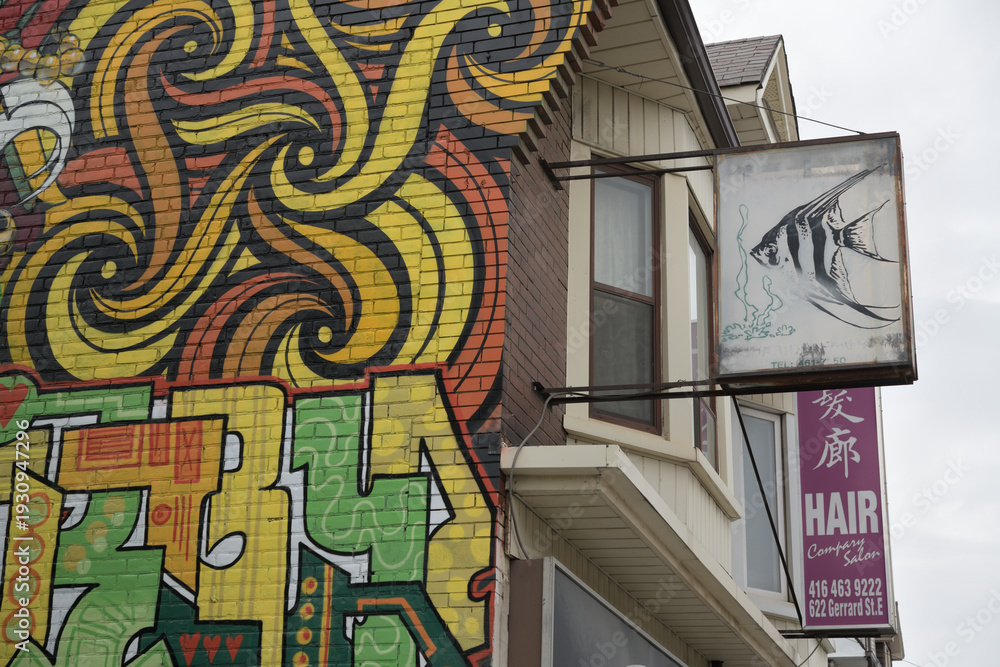 Obraz premium fancy mural on the (west facing) exterior wall of 620 Gerrard St E, Toronto (with projecting ghost sign featuring a fish)