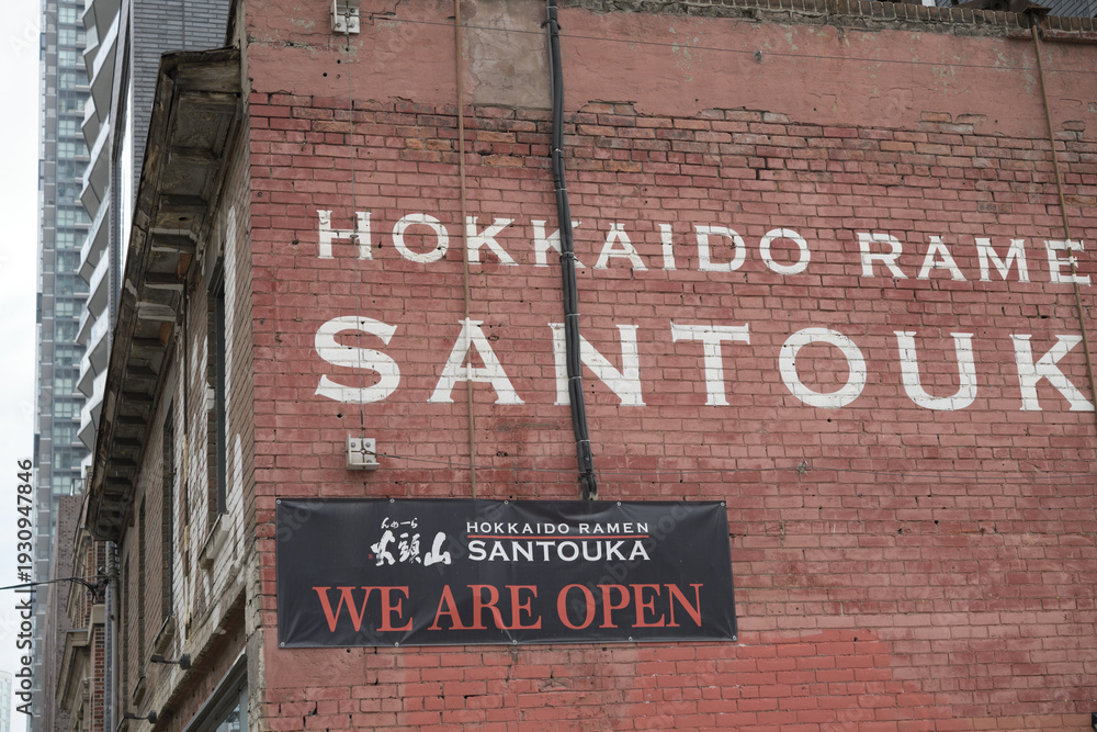 Fototapeta premium exterior building wall with signage outside Hokkaido Ramen Santouka located at 91 Dundas St E, Toronto